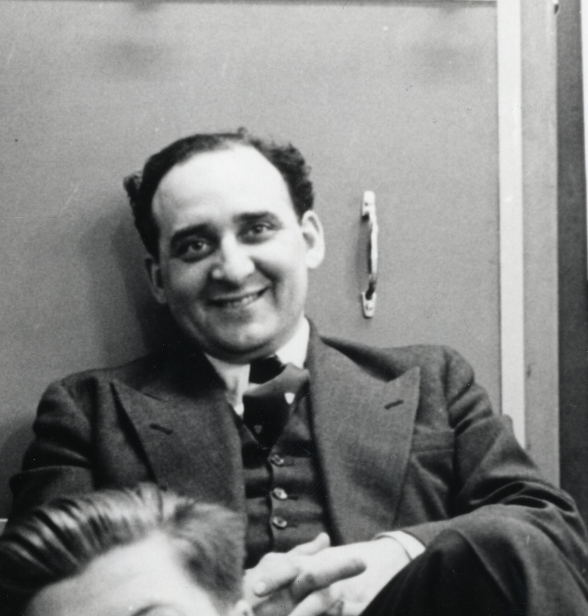 Photo of David Caminer leaning against panels of LEO I, c1952