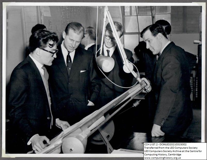 Photograph of 67805 Prince Philip examining a drafting board at Minerva Road